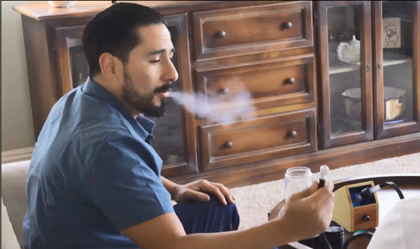 Person using the Vaporbrothers VB1.5 desktop dry herb ball vape hands-free